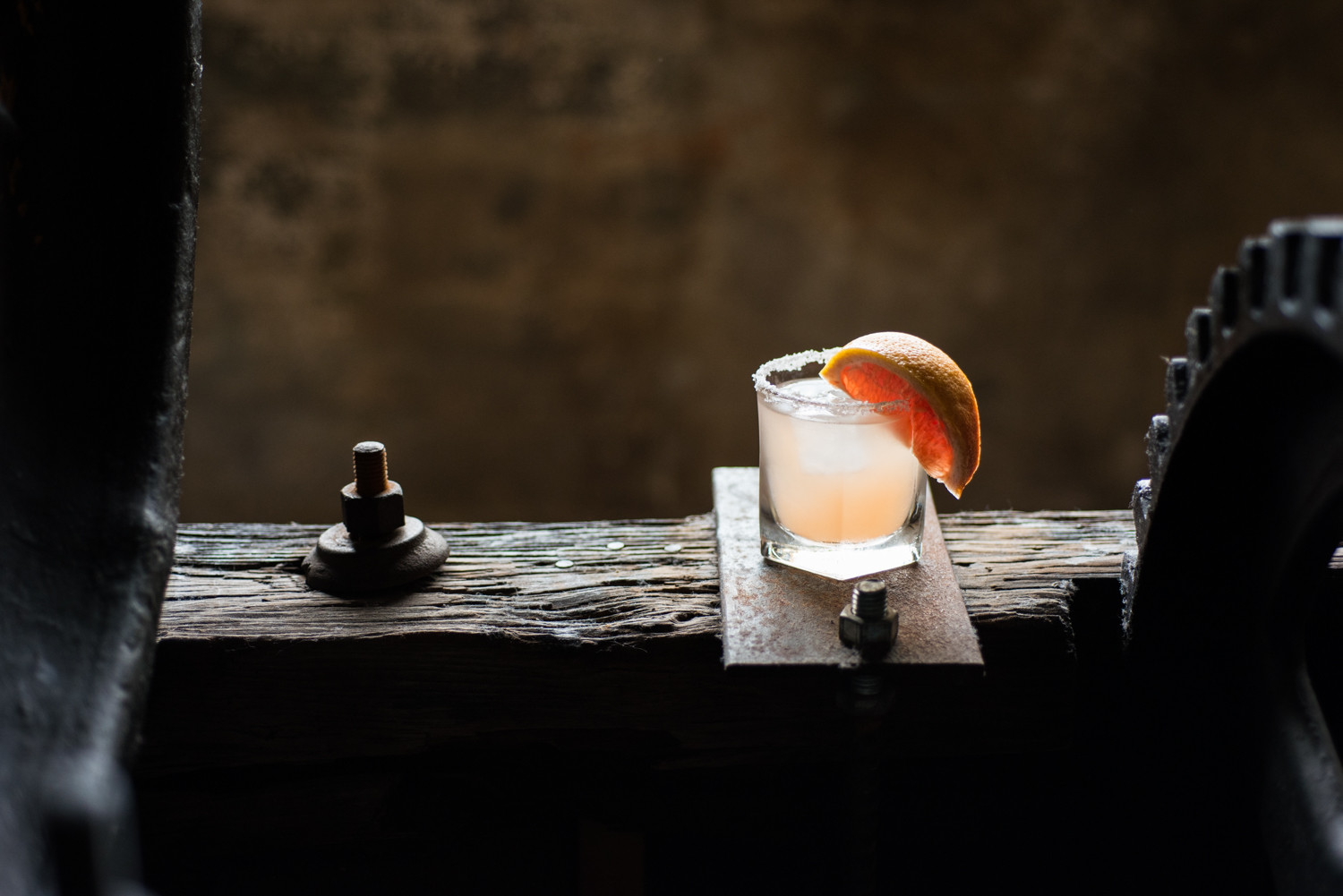 Grapefruit craft cocktail on rustic wood