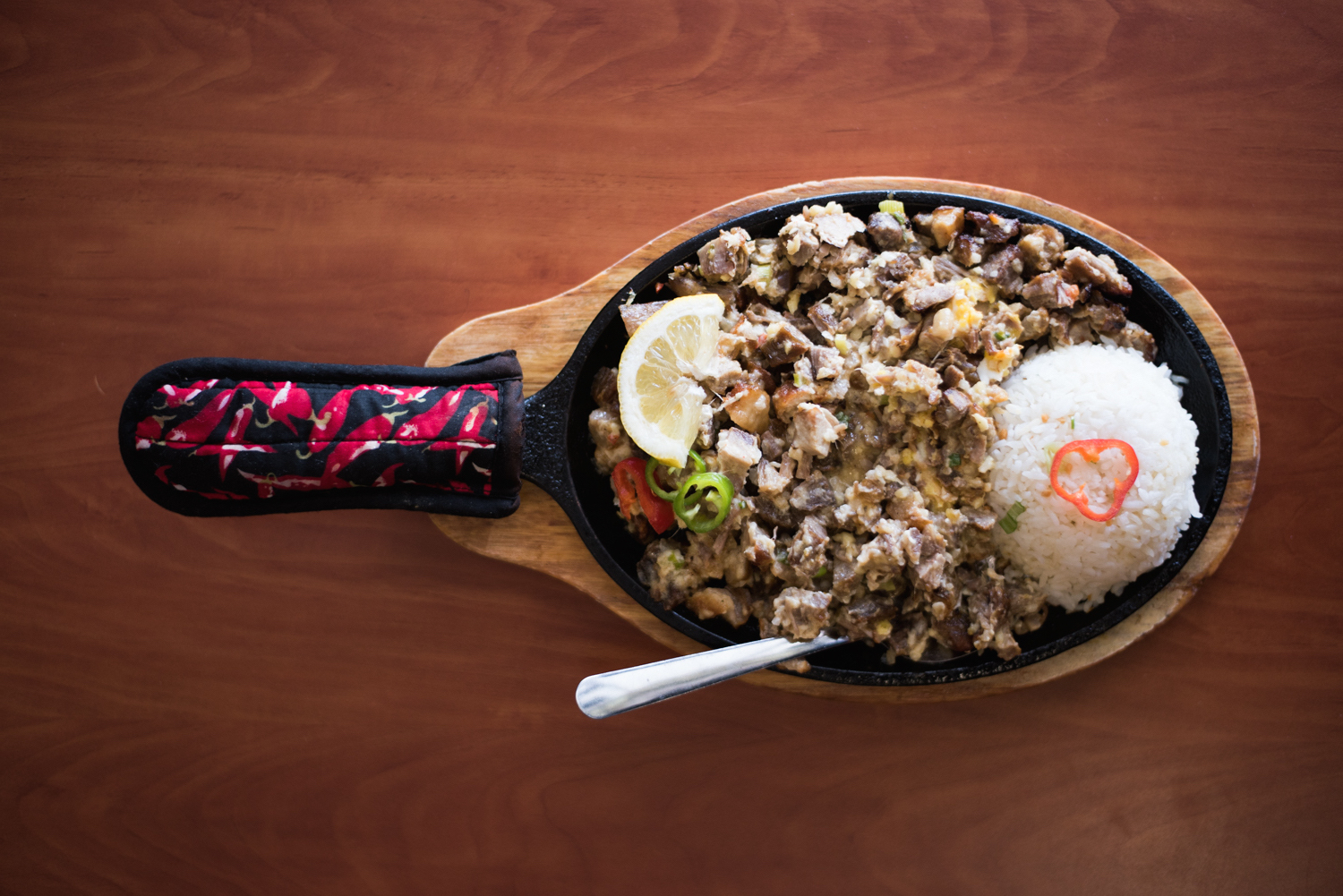 pork sisig on a sizzling plate with rice
