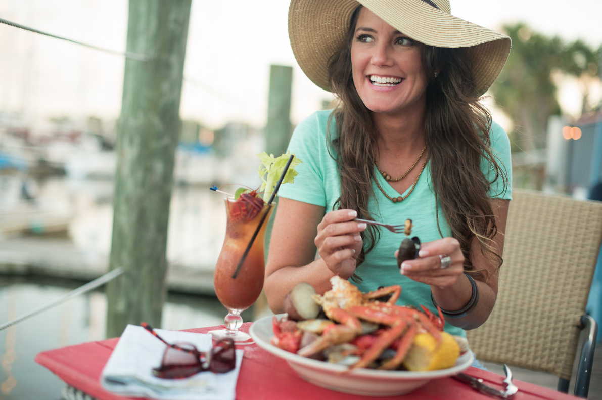 Woman eating seafood in Northeast Florida