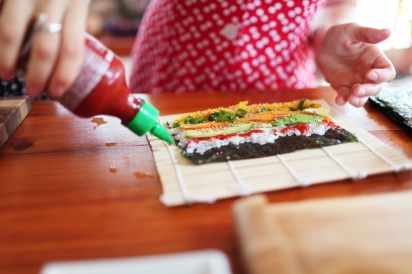 preparing a sushi roll