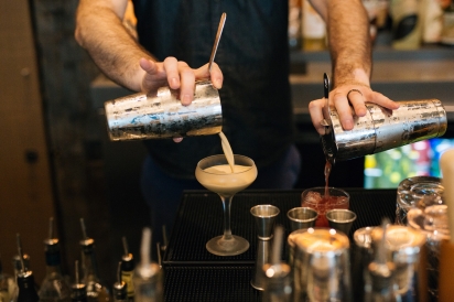 Austin Reinhard pouring cocktail
