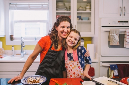 mother and daughter cooking in kitchen