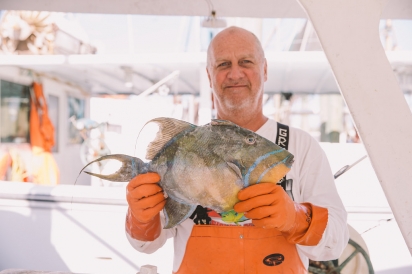 Commercial fisherman with fish in hands Jacksonville