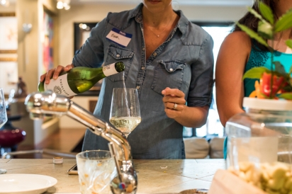 Woman pouring wine at counter