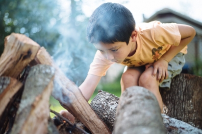 boy lighting campfire