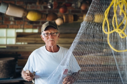 Frank Gassman mending nets