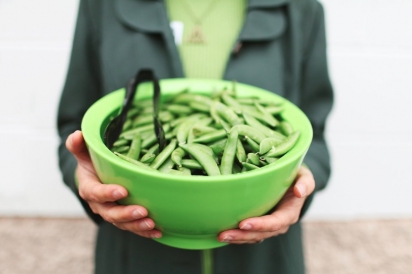 Woman holding bowl of peas