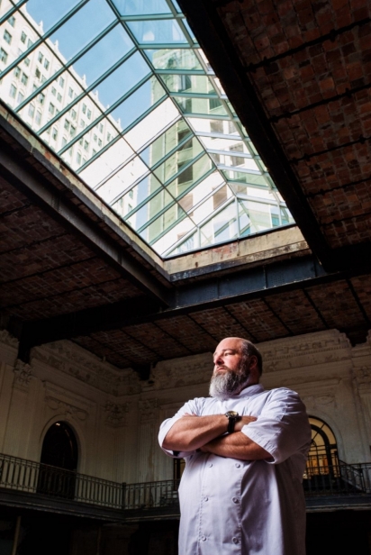 Chef Scott Schwartz stands under a glass ceiling in downtown Jacksonville at what will soon be the Bullbriar Restaurant