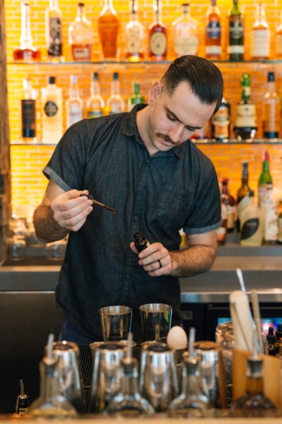 Austin Reinhard making cocktail