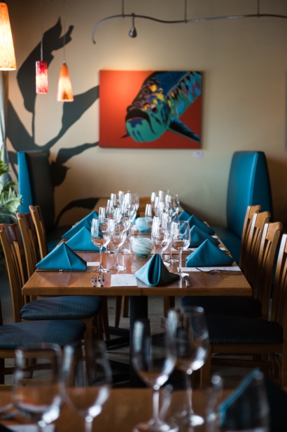 blackfly restaurant table setting with fish print on wall