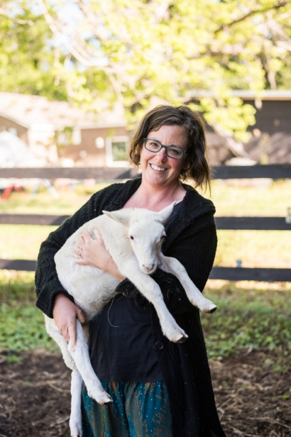 Farmer Jessi Patti at Juicy roots farm with lamb