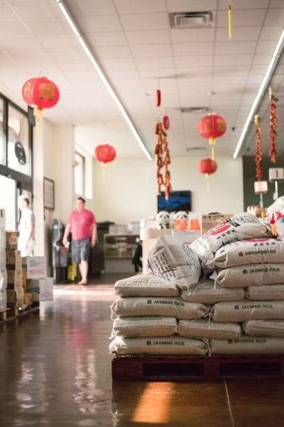 The entry way and bags of stacked rice at Hung Thinh in jacksonville florida