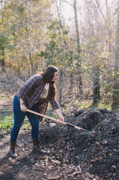 Tiffany Bess turns compost pile