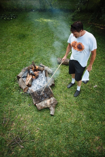 man building campfire ring
