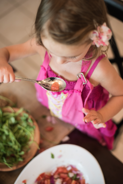 Little Girl learning to cook and sample food at home in st. Augustine florida 