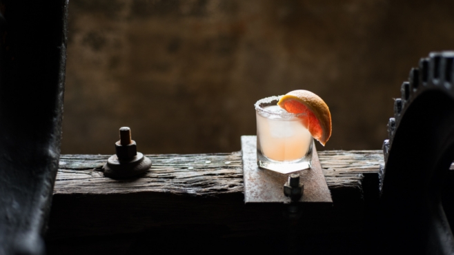 Grapefruit craft cocktail on rustic wood