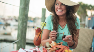 Woman eating seafood in Northeast Florida
