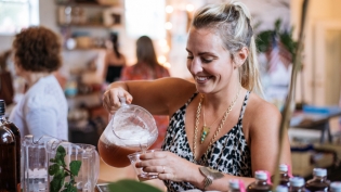 Girl pouring Gin fiz at a cocktail party