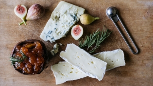 cheese rosemary and fig preserves on a cutting board